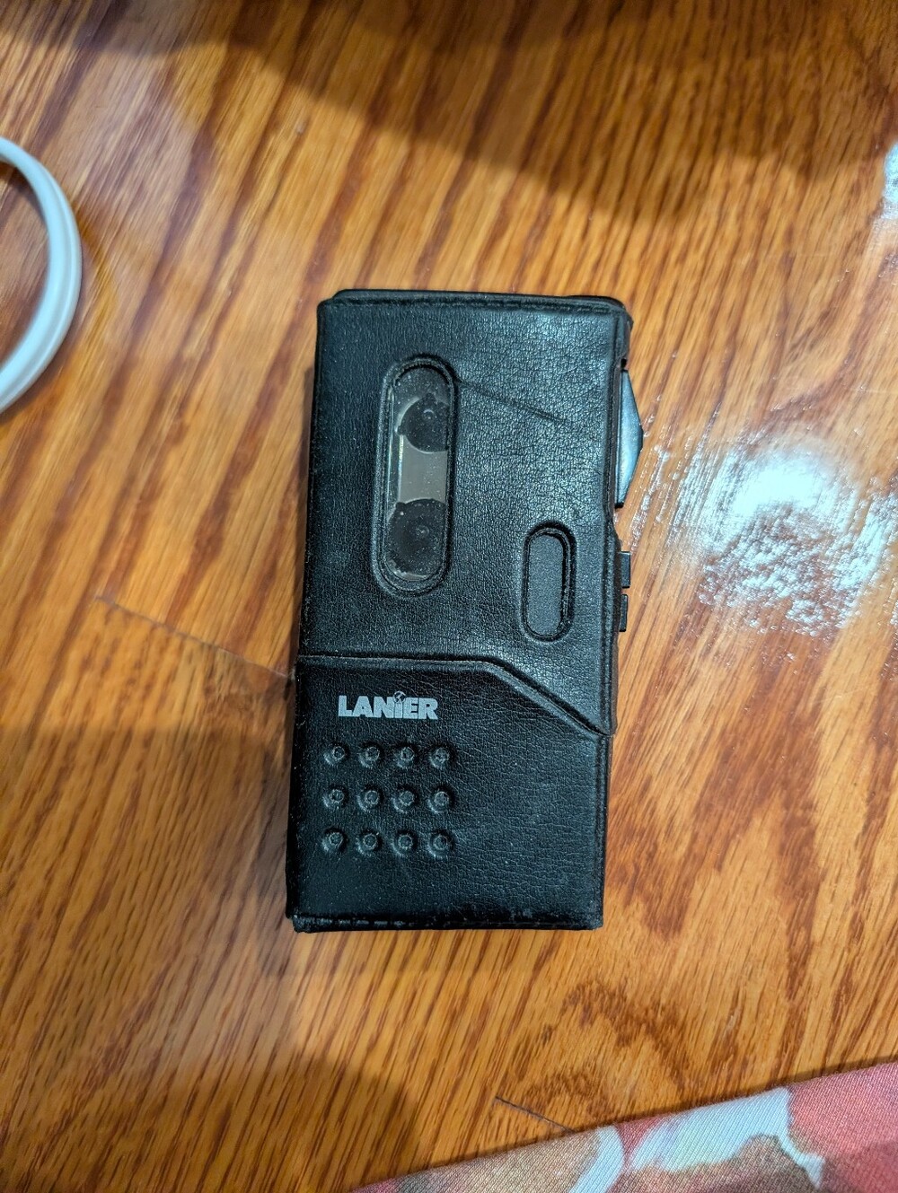 vintage Lanier Microcassette Voice Recorder housed in a black leatherette Case.